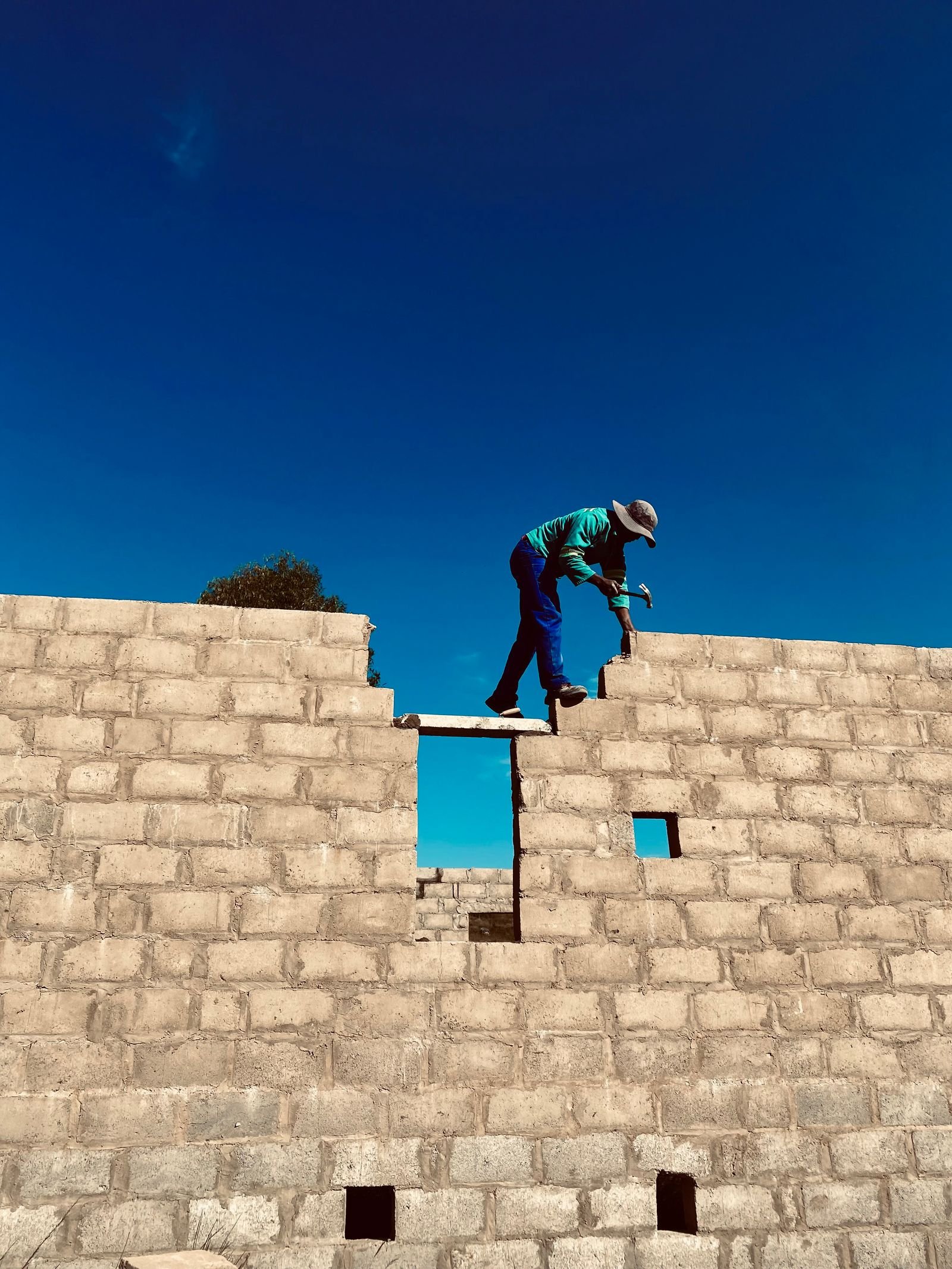 Construction Worker on Concrete Wall