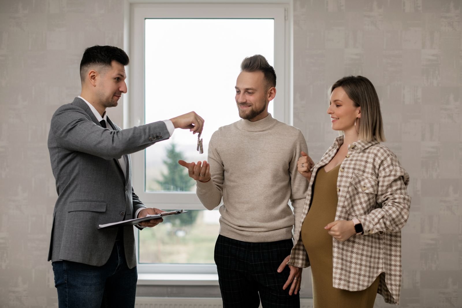 Real Estate Agent Handing the Key to New Homeowners