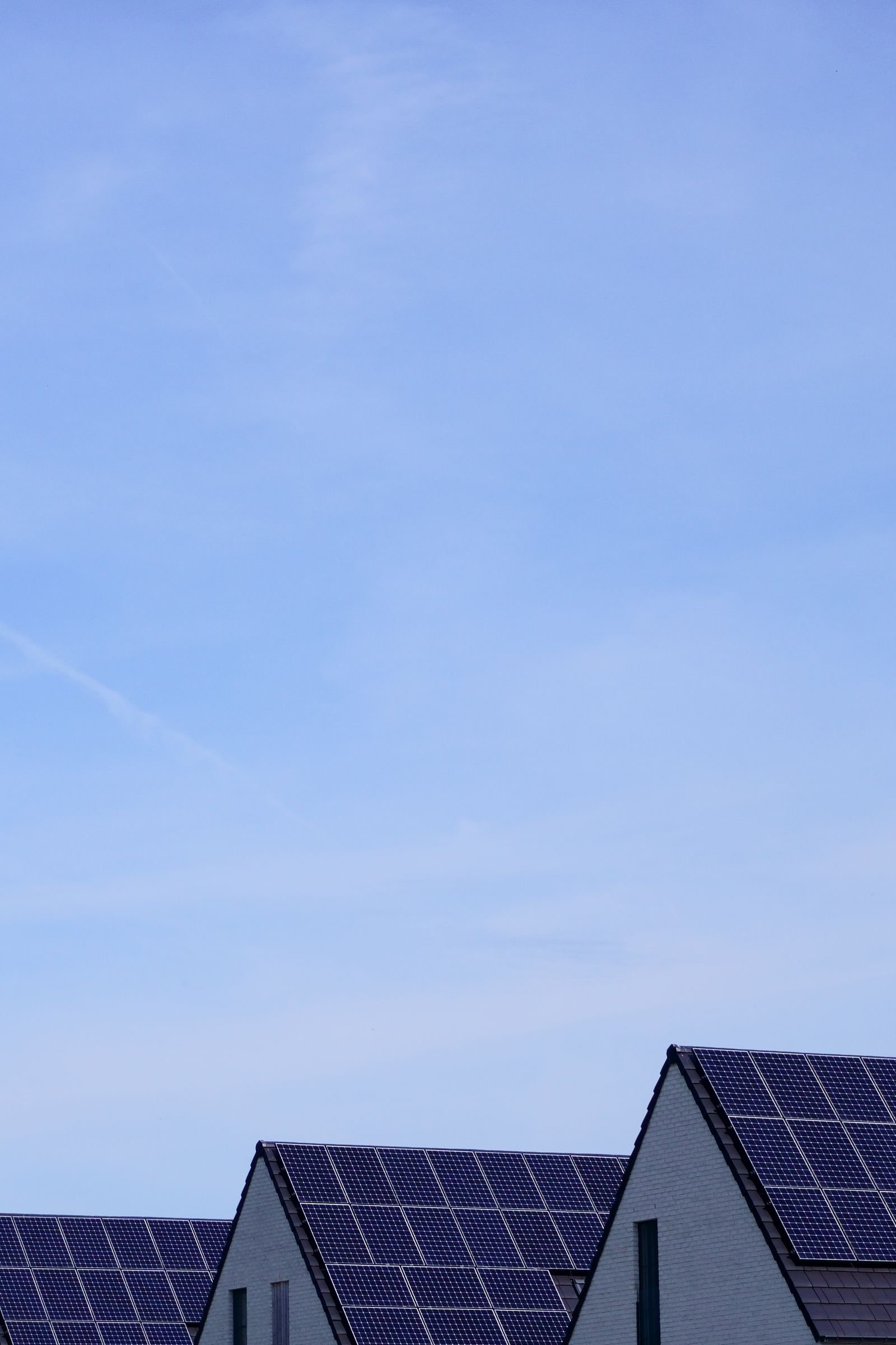 Residential Villas with Solar Panels Under Blue Sky