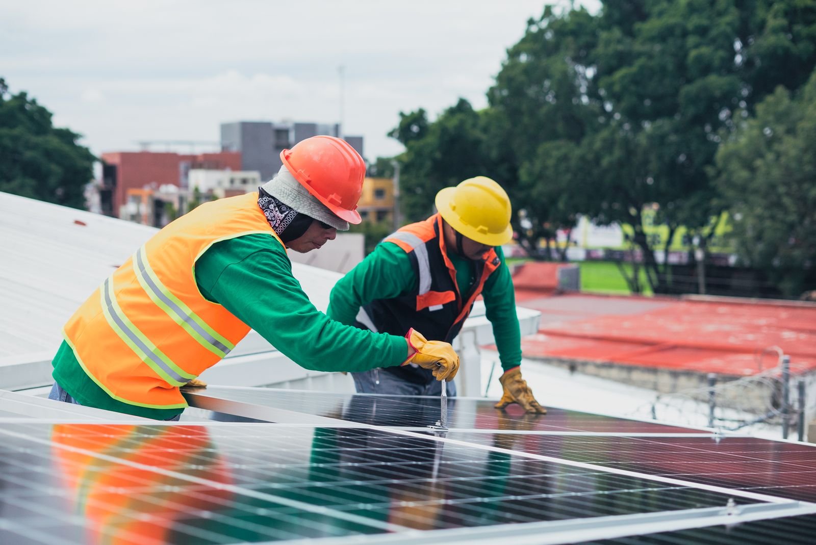 Two Technicians Installing Rooftop Solar Panels